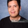 Studio portrait of a happy latin man yearbook style with blue background and sweater. Style 90s